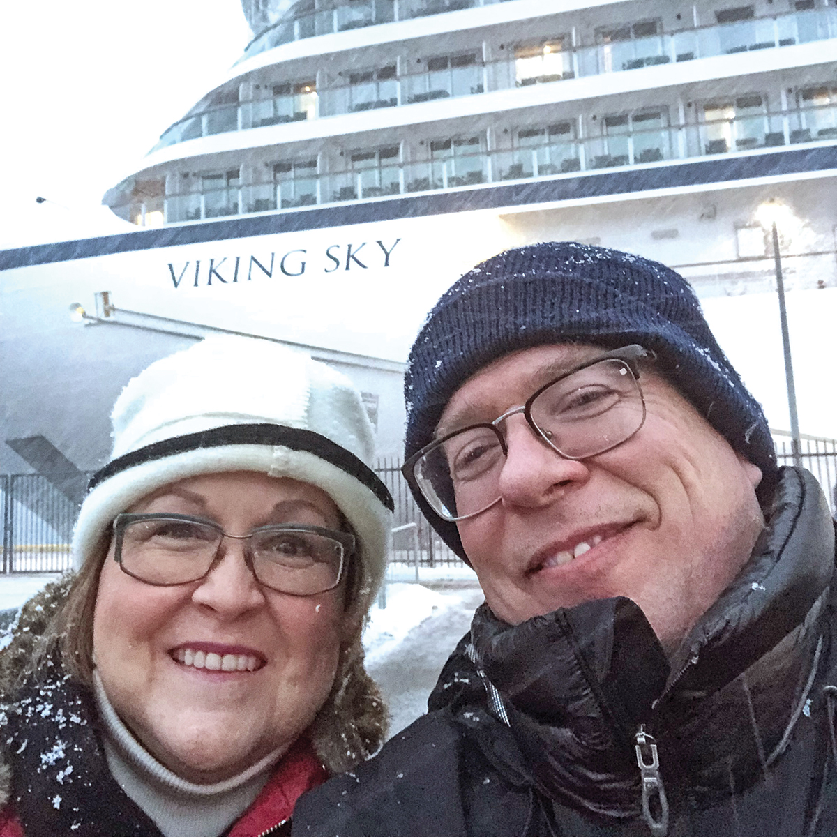 Rochester couple posing in front of a Viking Cruise they were later air lifted from 
