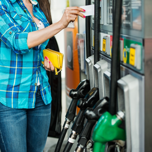 woman at gas pump paying