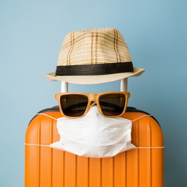 image of luggage wearing a mask and sunglasses