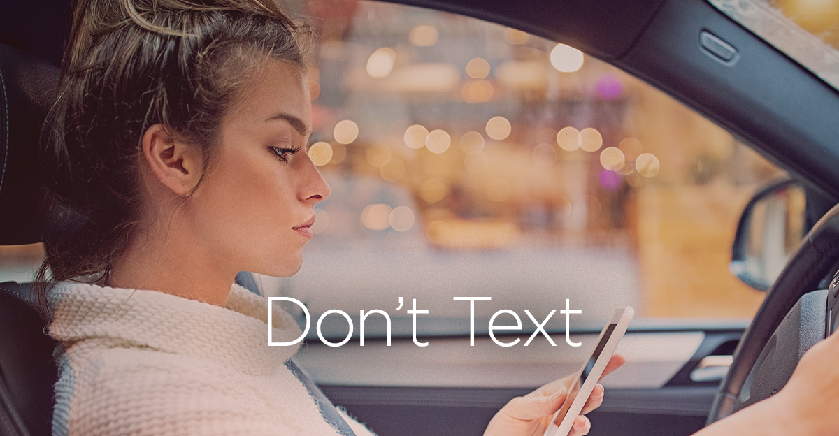 don't text and drive image female in car on phone