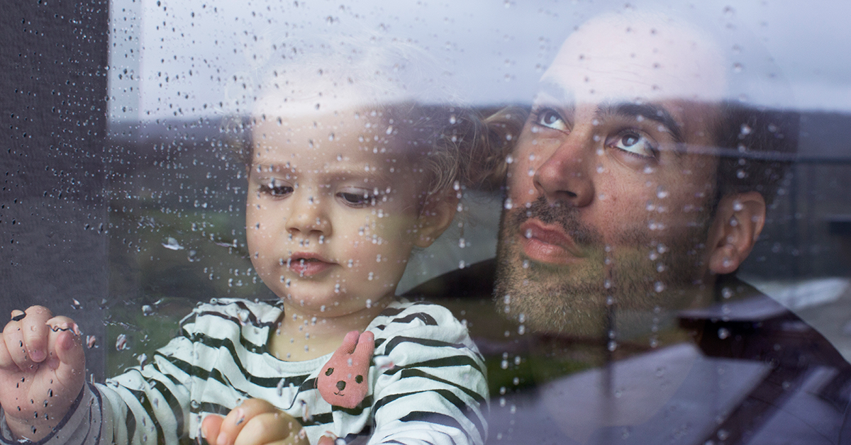 father and child watch storm