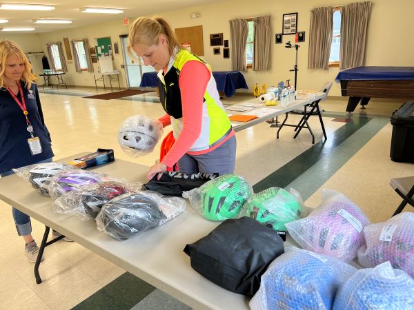 Cortland County Health Educators set up new helmets for fittings.
