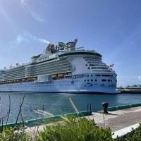 A Royal Caribbean cruise ship is docked at port.