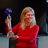 Carol DiOrio, Vice President of Travel at AAAWCNY, holds the 2021 Allianz Partners Top Club Award.